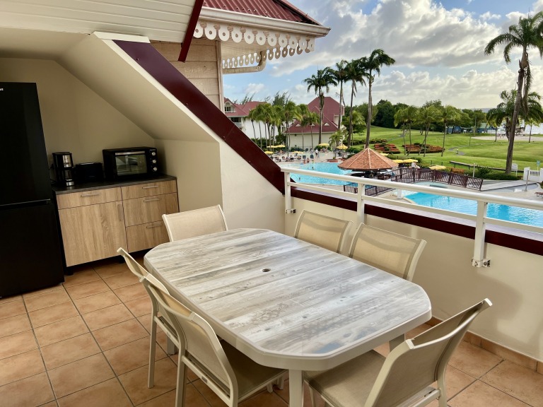 Cuisine, vue mer et piscine, table et chaises, mini-four, réfrigérateur congélateur, grille-pain, cafetière